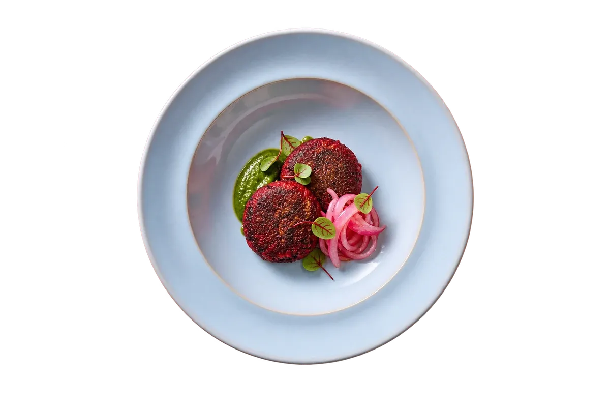 Barolo dinnerware serving beetroot galouti with a little mint chutney and pickled onion.