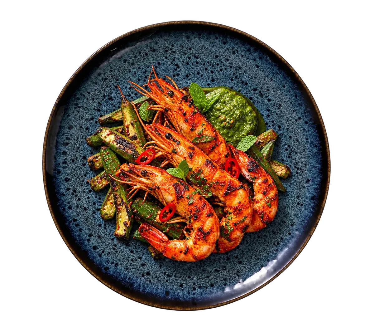 Eccentric dinnerware serving tandoori prawns with charred okra and a little mint chutney.