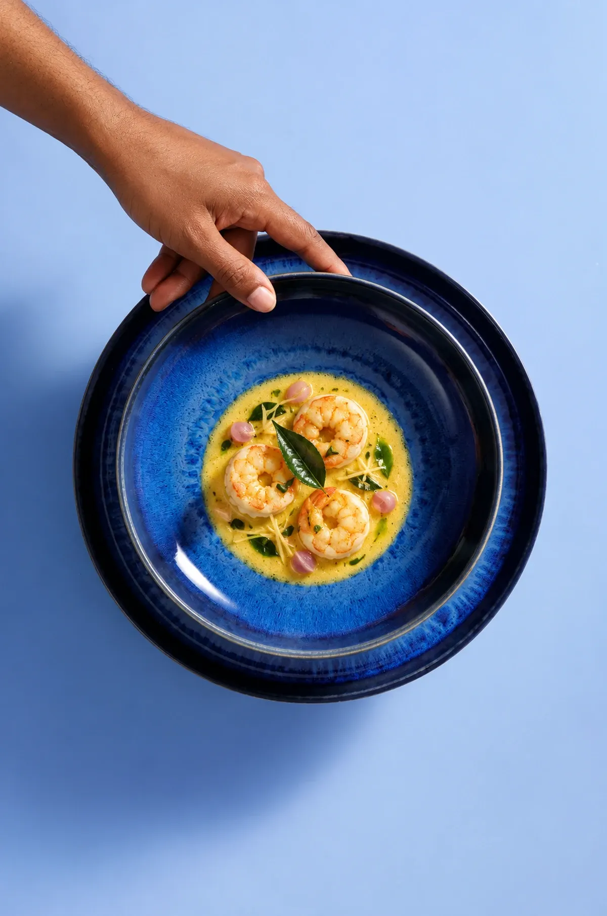 Kerala prawn moilee on cobalt dinnerware.
