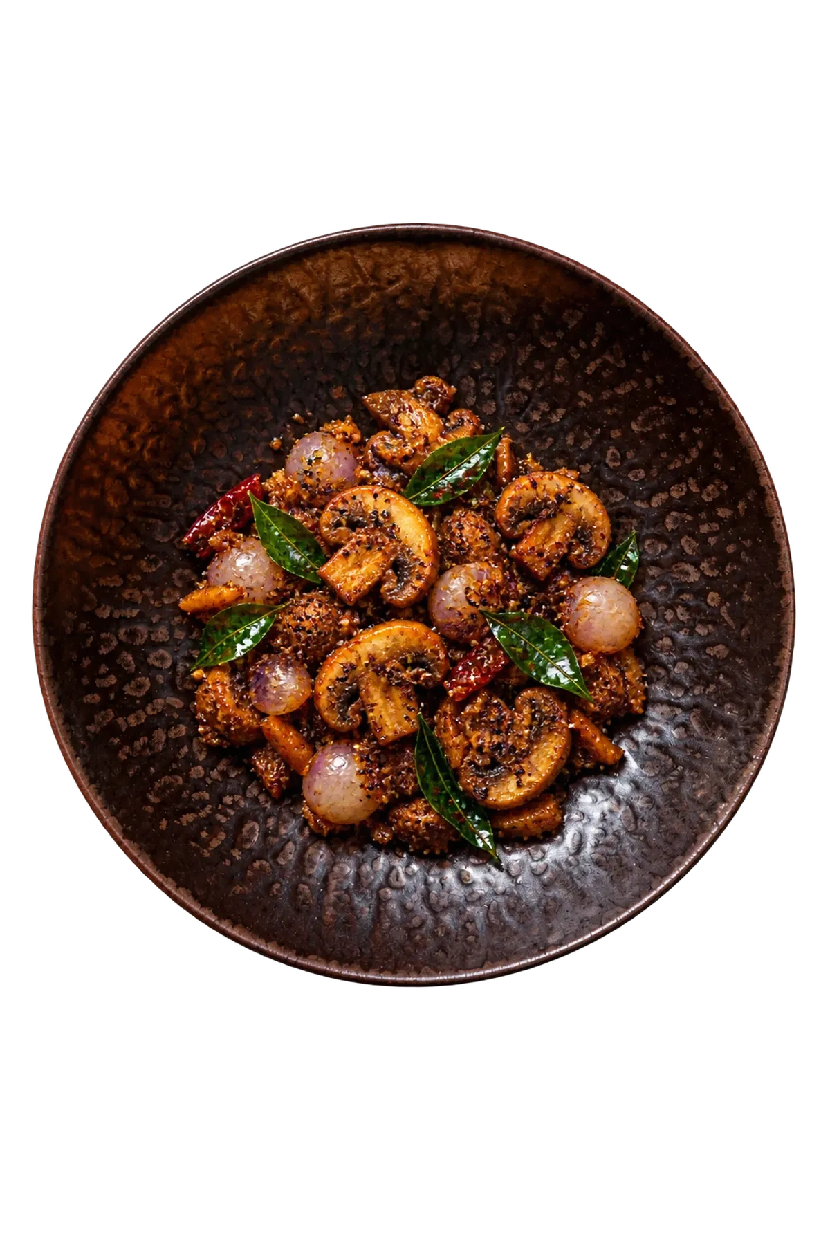 Ruston dinnerware serving Chettinad mushroom pepper fry with pearl onions and curry leaves.